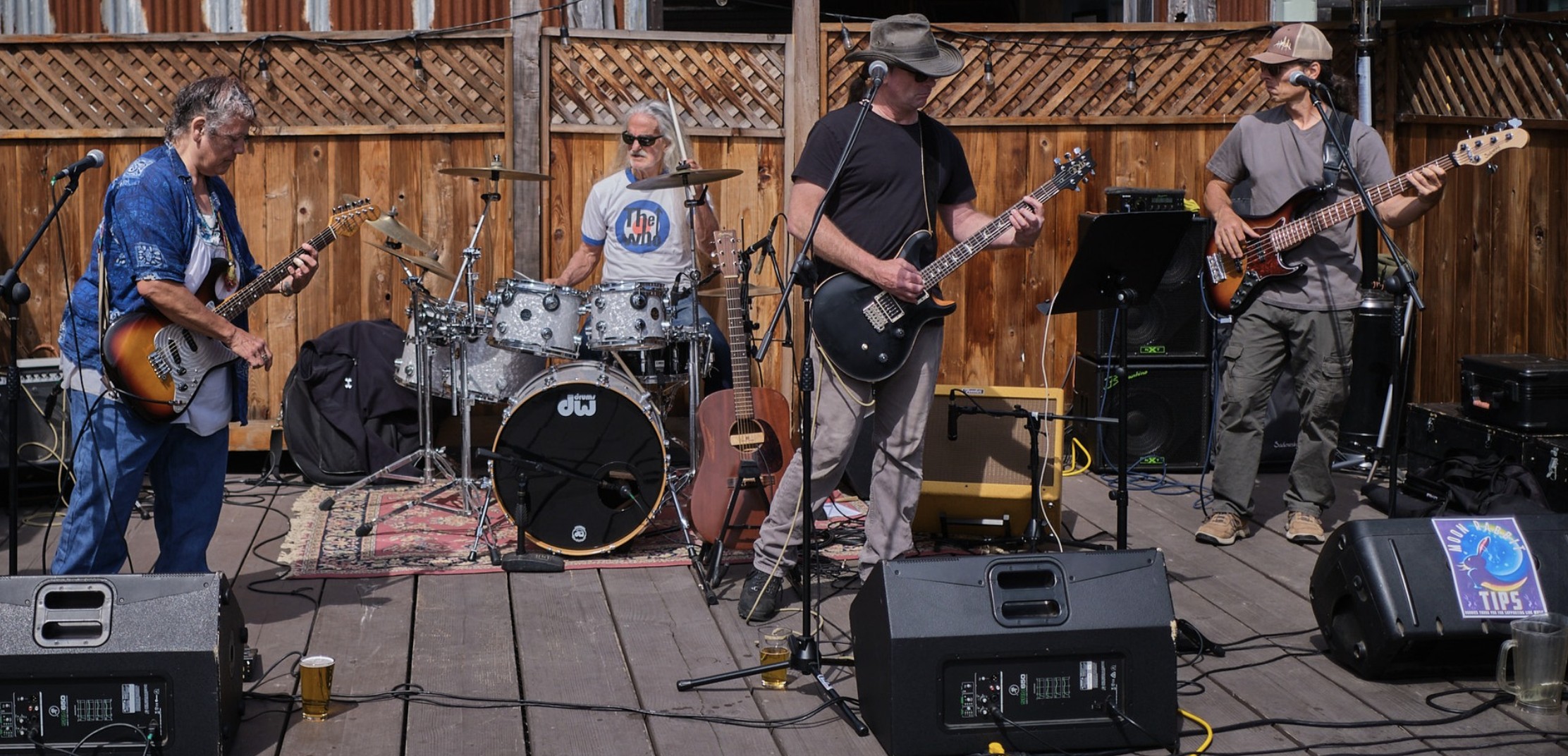 A picture of a rock band playing rock musical instruments