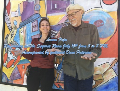 Laura Pope and Dave Paterson standing in front of a mural.