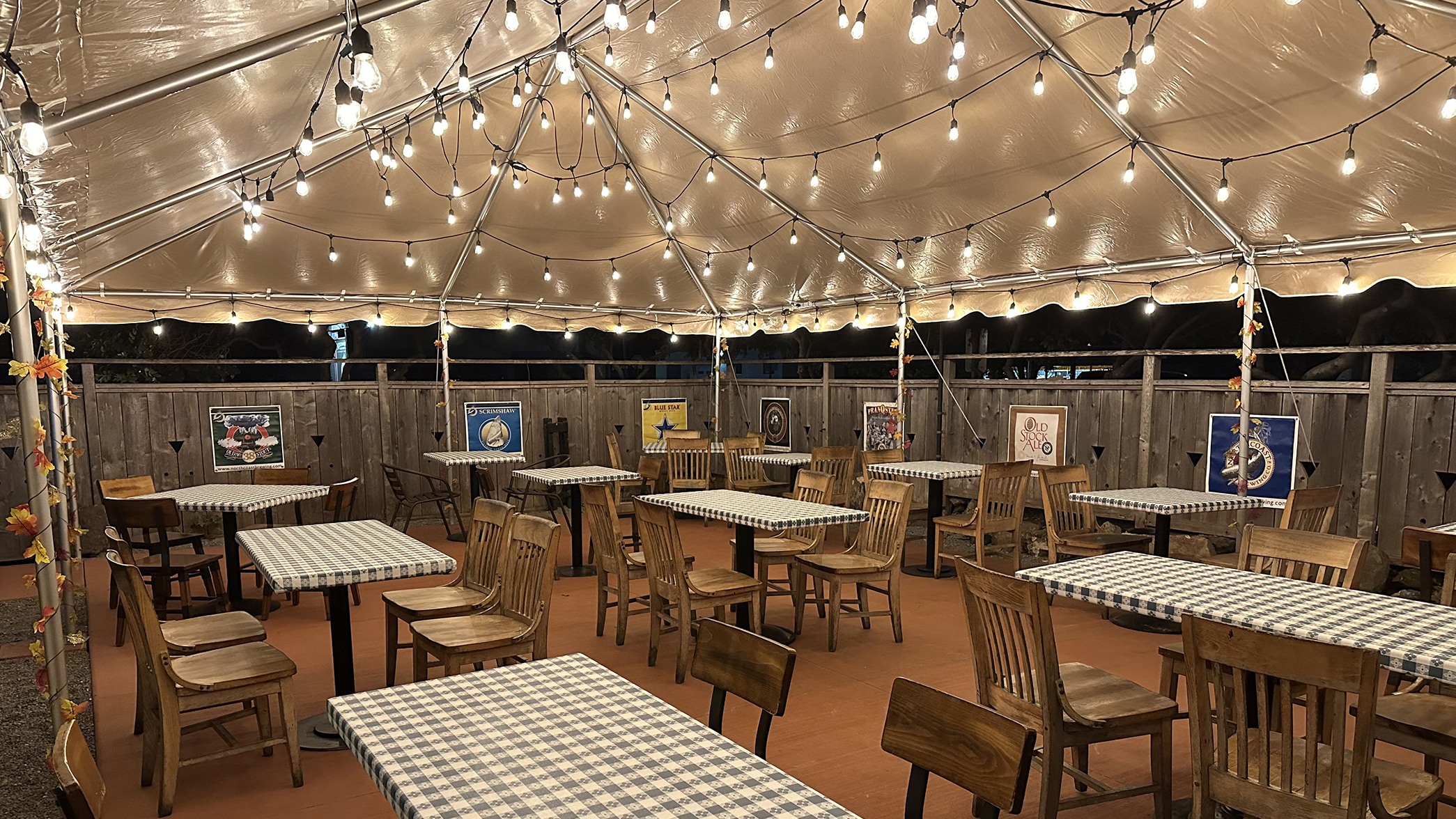 A picture of the new garden area at our pub. The photo is taken inside a tent and you can see the garden lights and beer banners.