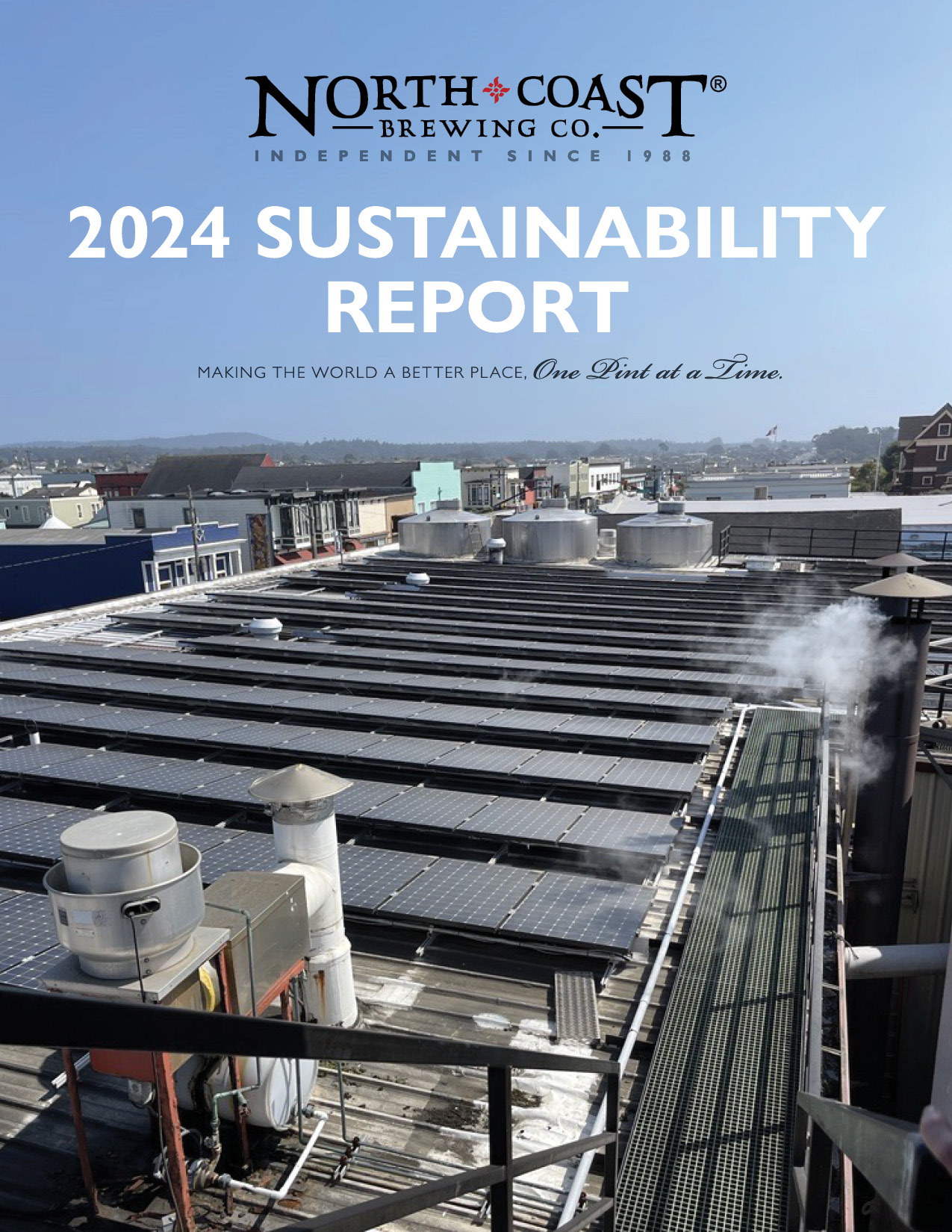 2024 Sustainability Report title above solar panels that cover our brewery's roof. In the distance you can see the city of Fort Bragg, California