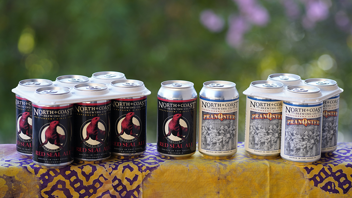 Red Seal Ale and PranQster 6- and 4-packs with single beer cans outdoors.