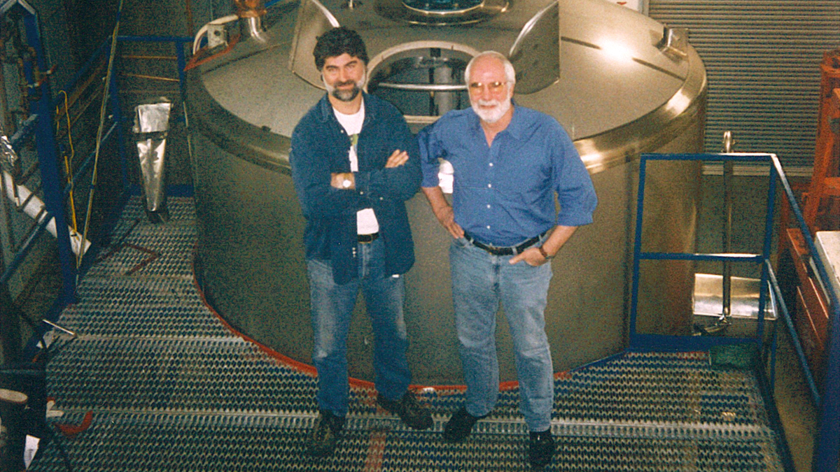 Co-Founders Mark Ruedrich and Tom Allen standing in front of a tank in the newly-built brewhouse in 1994.