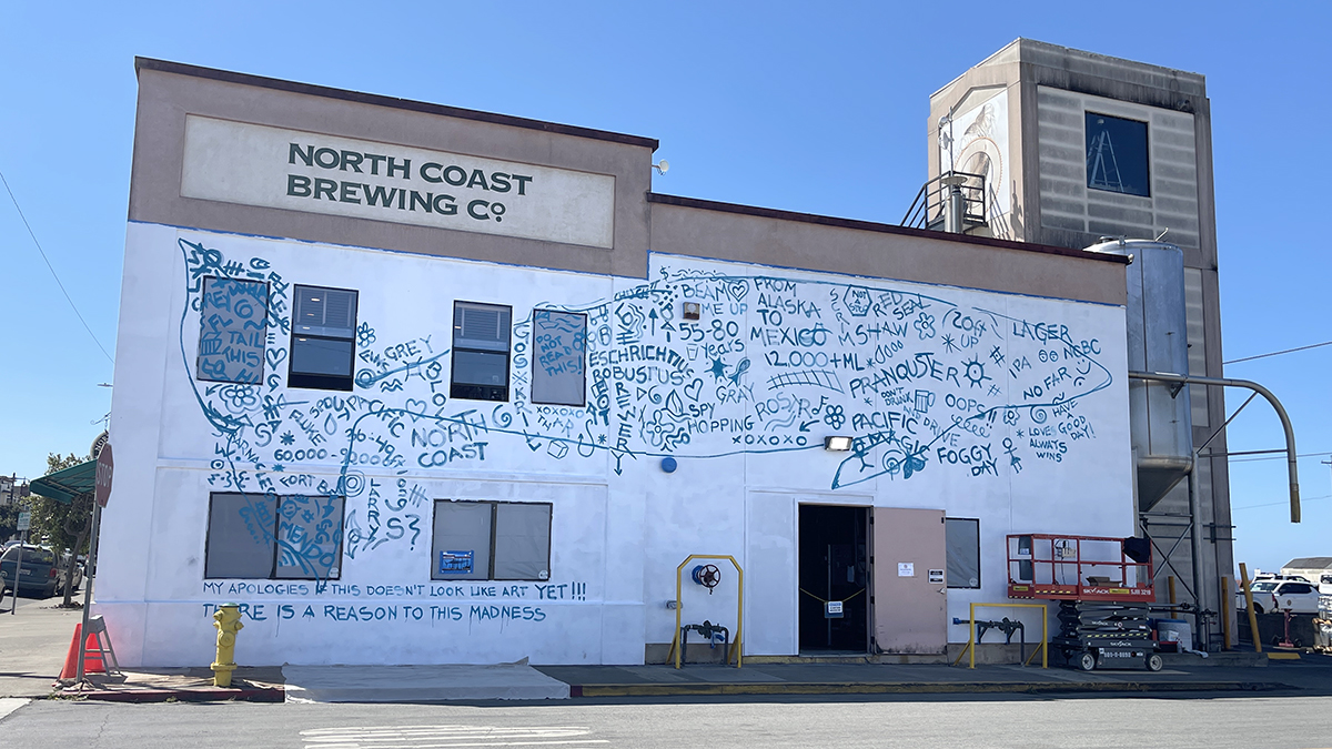 Full view of the whale mural outline with squiggle grid completely filled in.